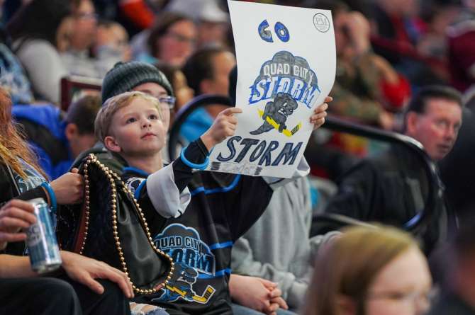 A fan holding up a sign